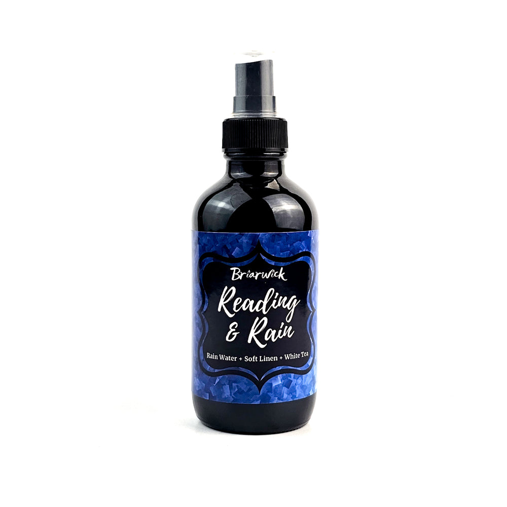 a bottle of blue liquid sitting on top of a white surface
