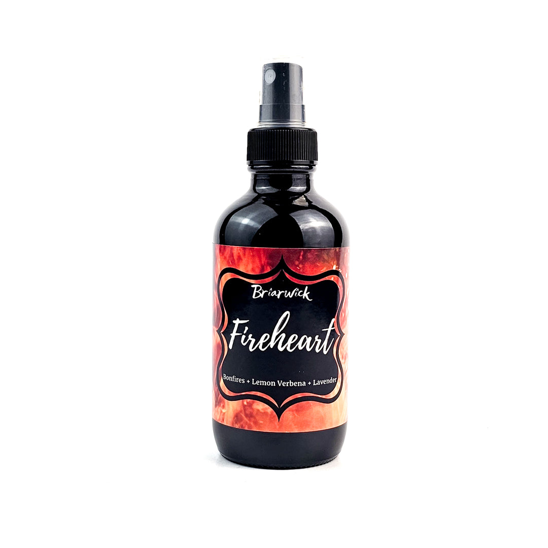 Fireheart 4oz Linen Spray with orange flame design on a white background