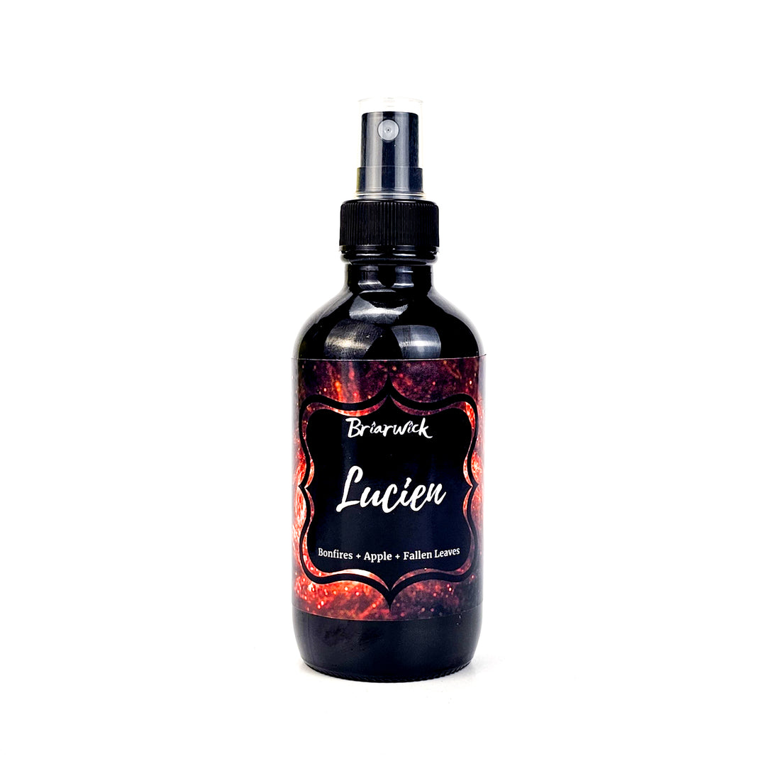 Lucien 4oz Linen Spray with orange galaxy design on a white background