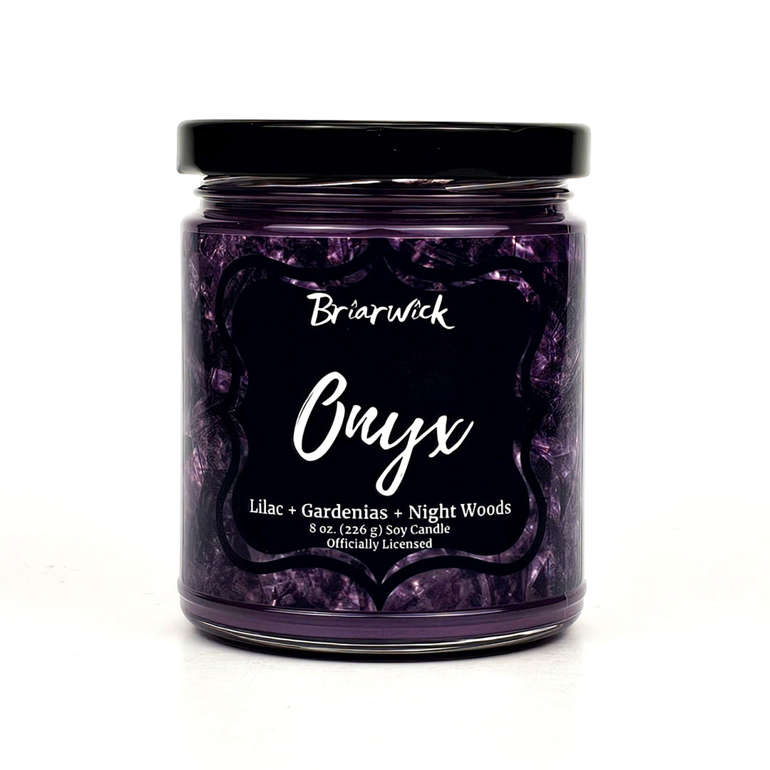 a jar of purple candles sitting on a white surface