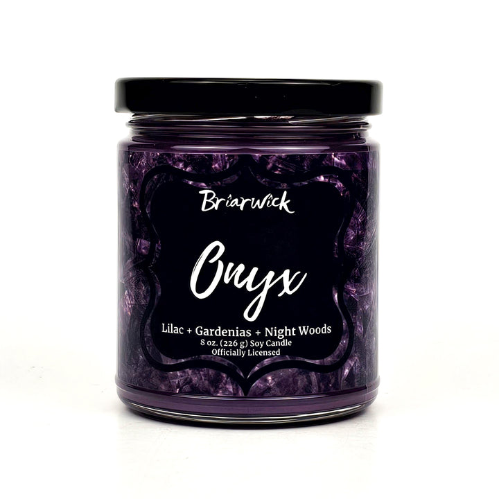 a jar of purple candles sitting on a white surface