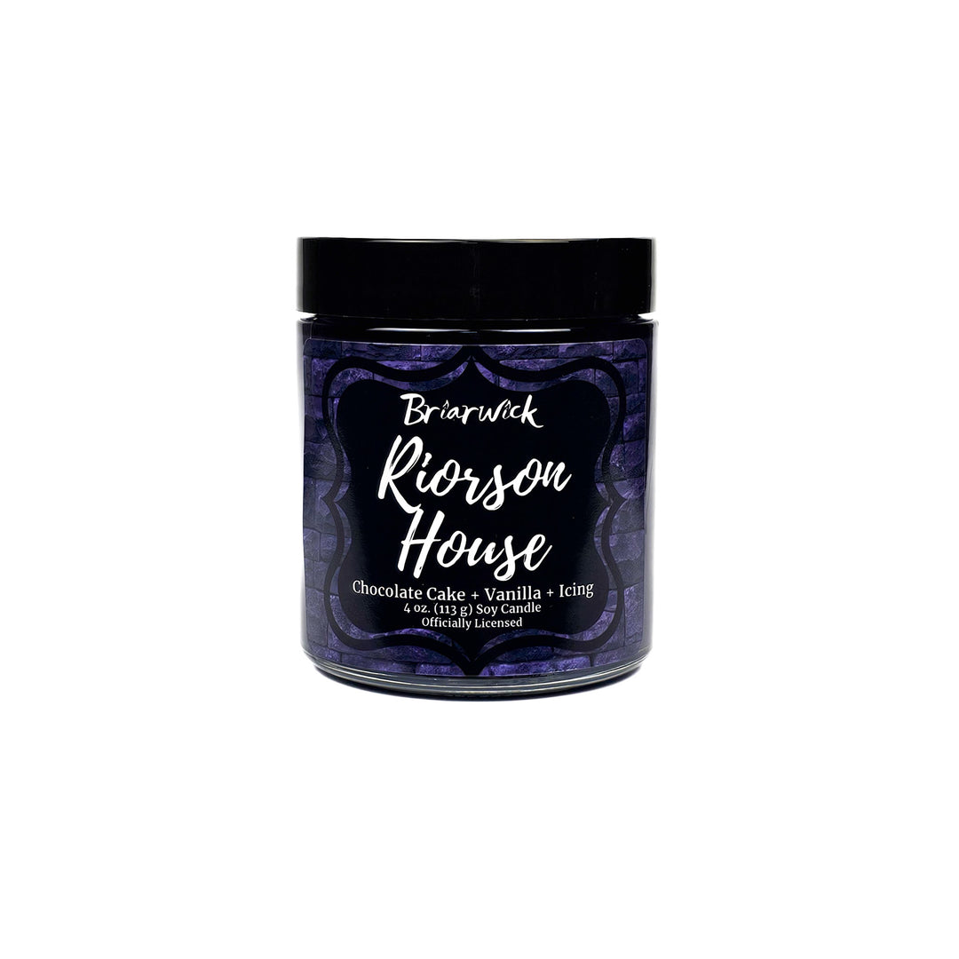 Riorson House 4oz eggplant candle with purple brick design on a white background