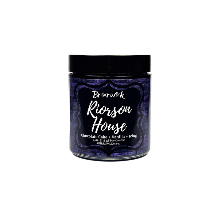 Riorson House 4oz eggplant candle with purple brick design on a white background