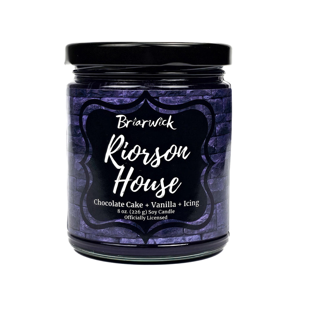 Riorson House 8oz eggplant candle with purple brick design on a white background