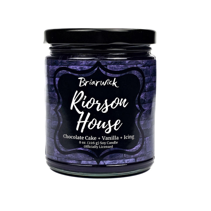 Riorson House 8oz eggplant candle with purple brick design on a white background