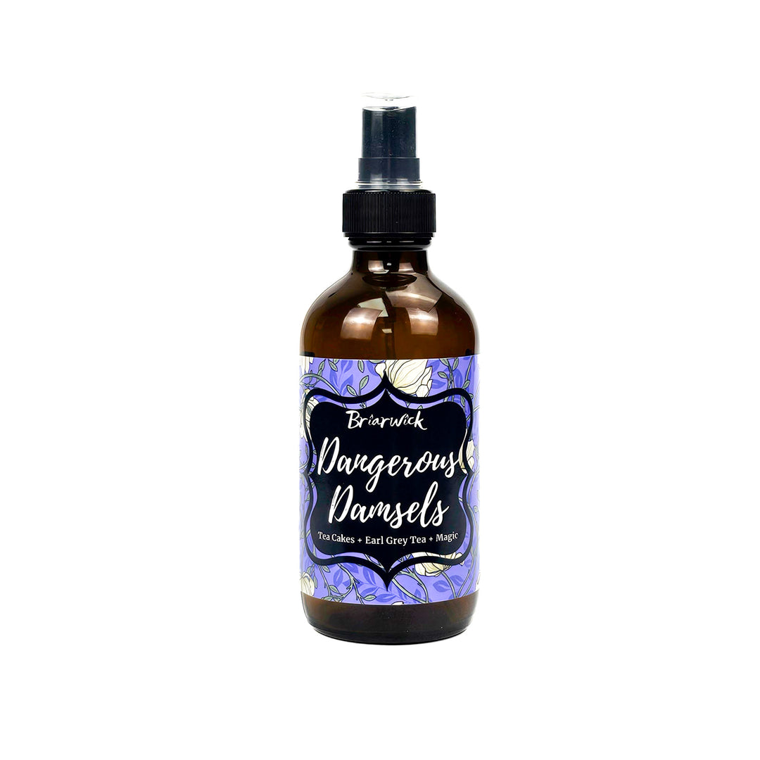 brown glass bottle with spray top and purple label that says Dangerous Damsels on a white background