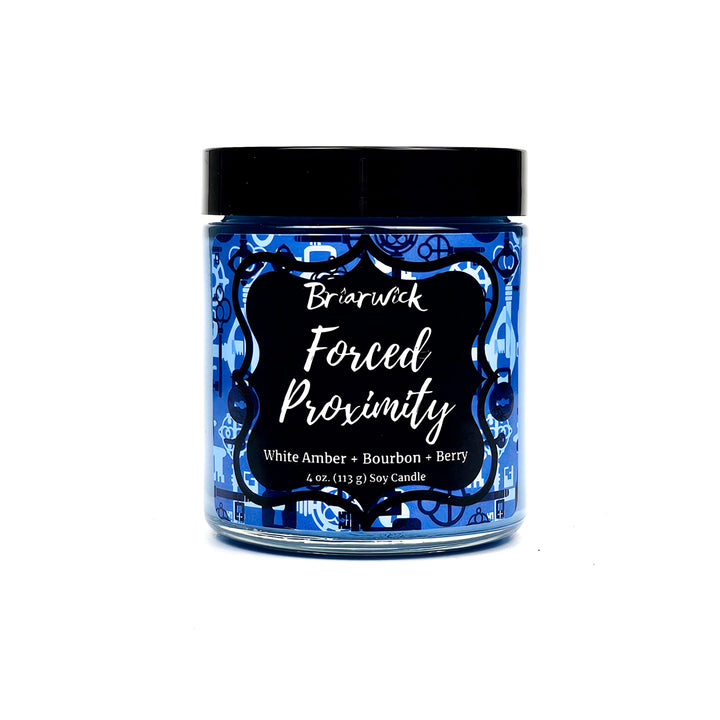 Forced Proximity 4oz steel blue candle with blue lock & key design on a white background