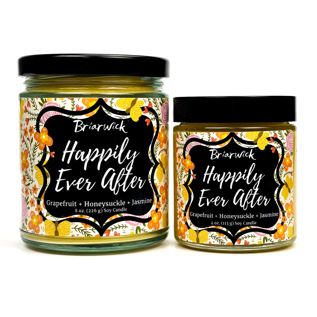 Happily Ever After 8oz & 4oz dandelion yellow candles with floral designs on a white background