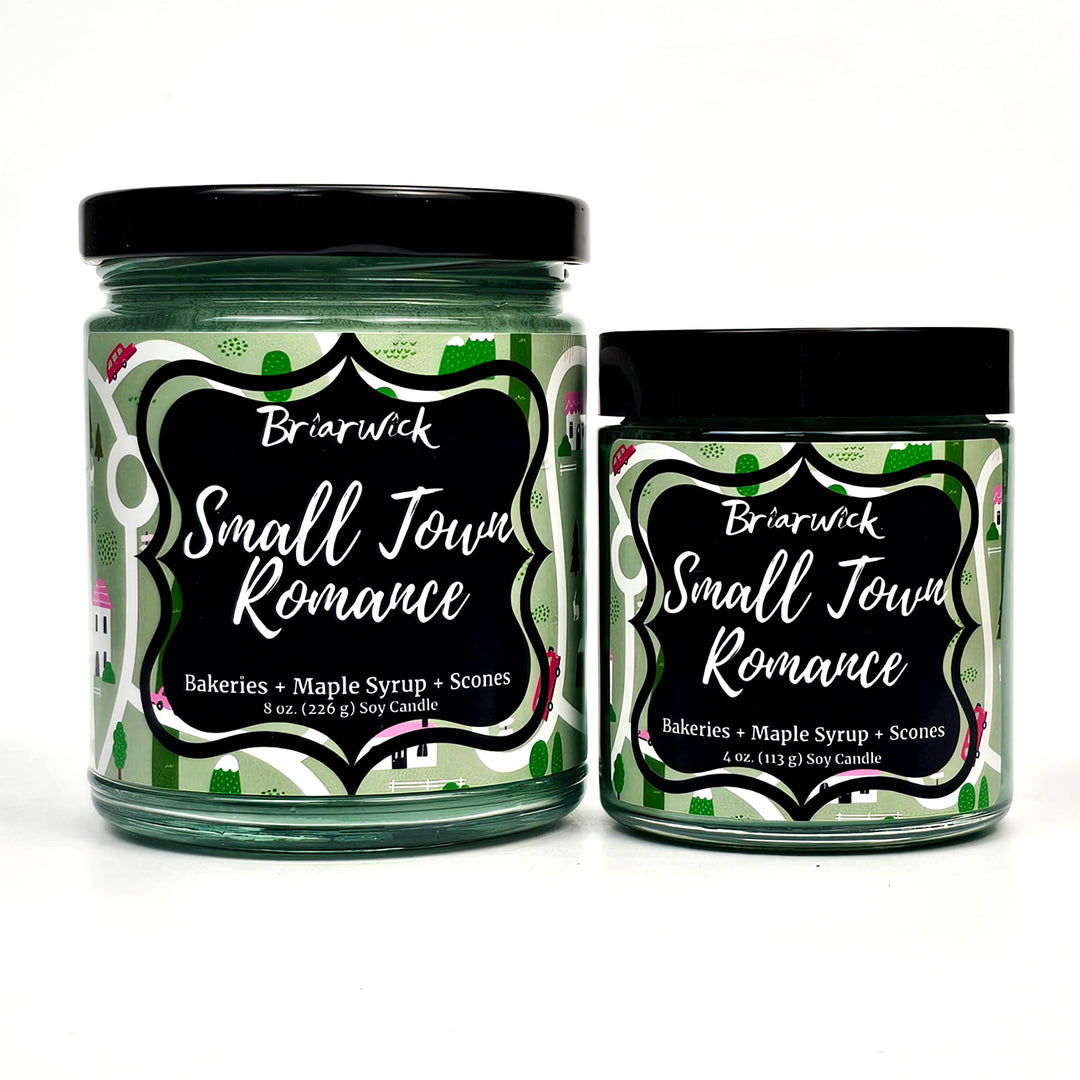 Small Town Romance 8oz & 4oz pastel green candles with green map designs on a white background