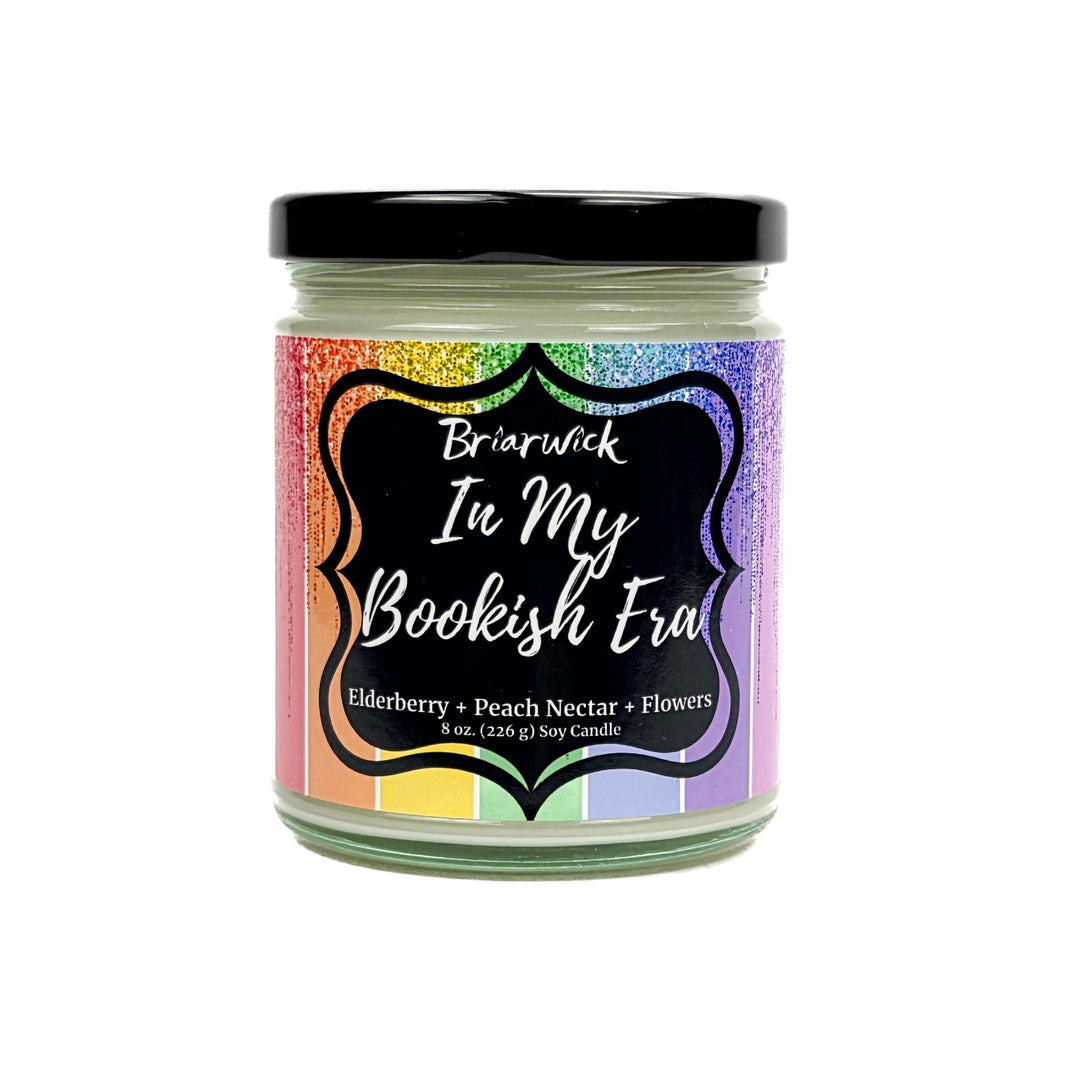 In My Bookish Era 8oz white candle with sparkly rainbow design on a white background