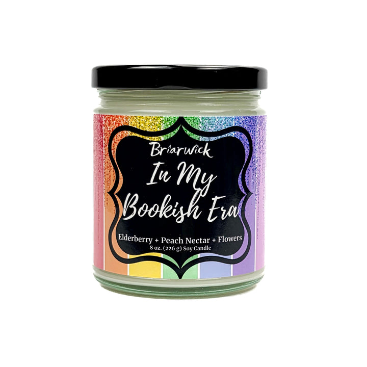 In My Bookish Era 8oz white candle with sparkly rainbow design on a white background
