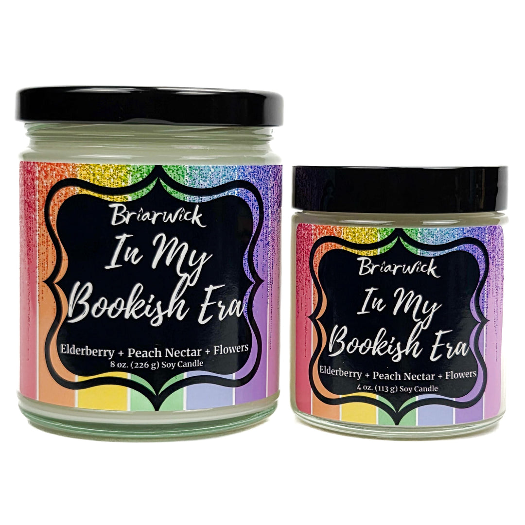 In My Bookish Era 8oz & 4oz white candles with sparkly rainbow designs on a white background