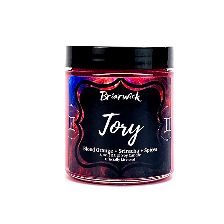 Tory 4oz cherry red candle with blue galaxy gemini design on a white background