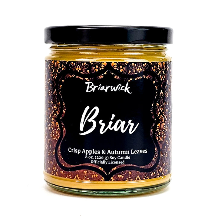 Briar 8oz custard candle with yellow ornamental design on a white background