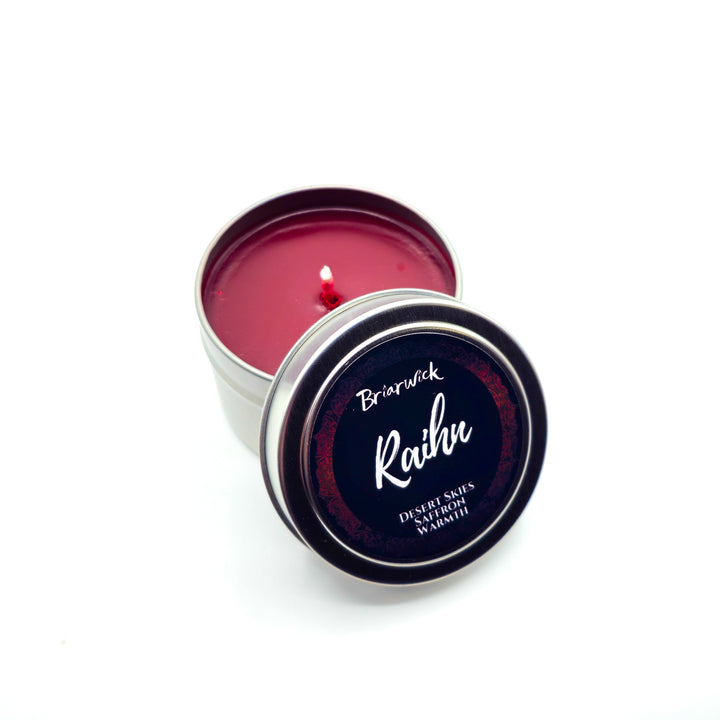 a tin of red wax sitting on top of a white table