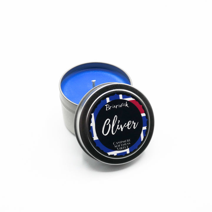 a tin of blue colored wax sitting on a white surface