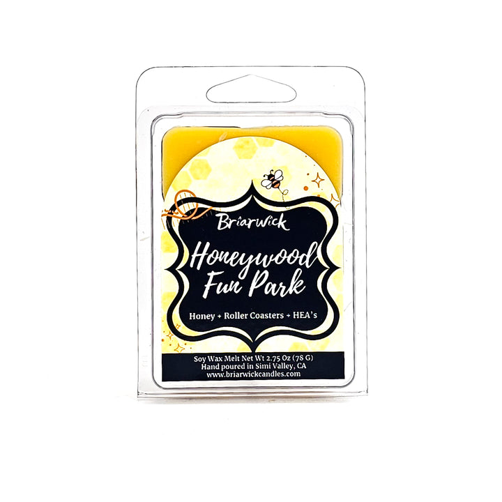 a yellow candle with a black label on it