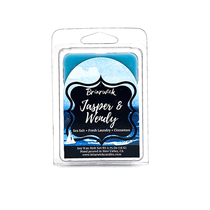 a blue candle with a black label on it