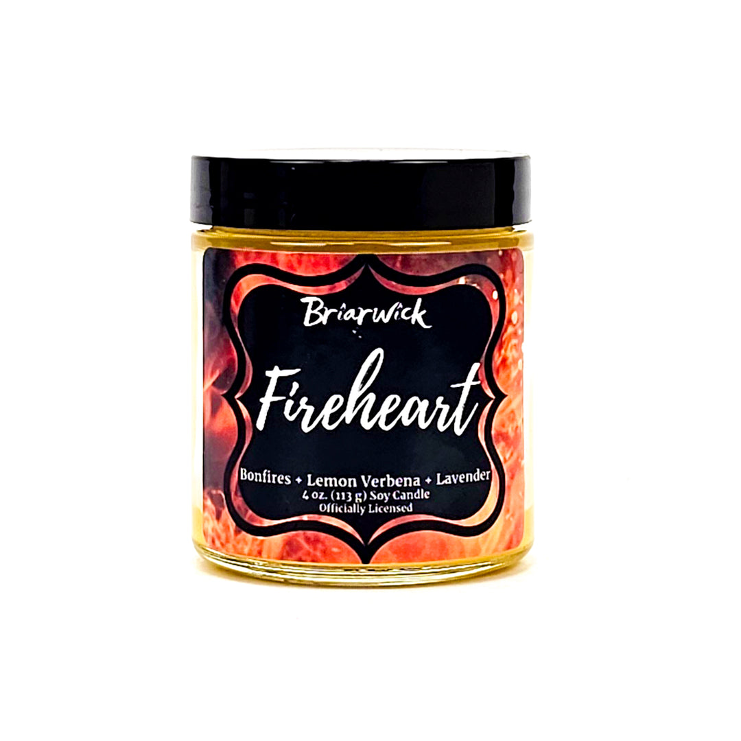 Fireheart 4oz canary yellow candle with orange flame design on a white background