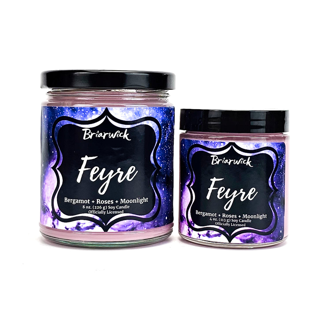 Feyre 8oz & 4oz powder pink candles with purple galaxy designs on a white background
