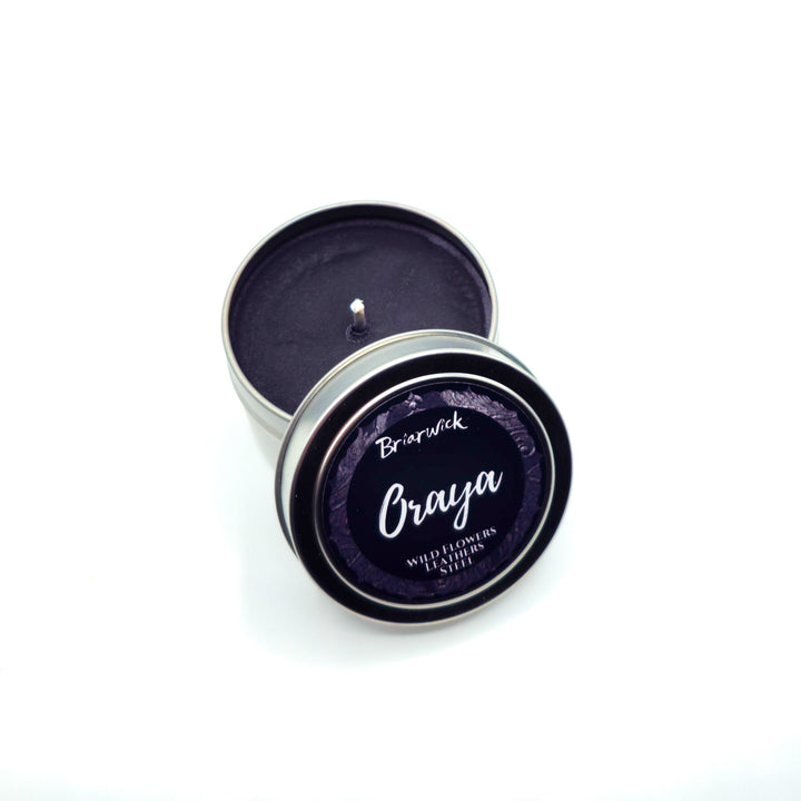 a small tin with a candle inside of it