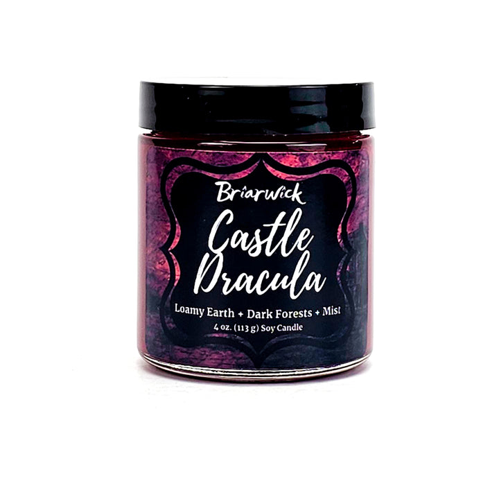Castle Dracula 4oz garnet candle with red parchment design on a white background