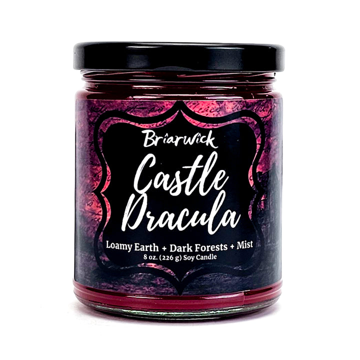 Castle Dracula 8oz garnet candle with red parchment design on a white background