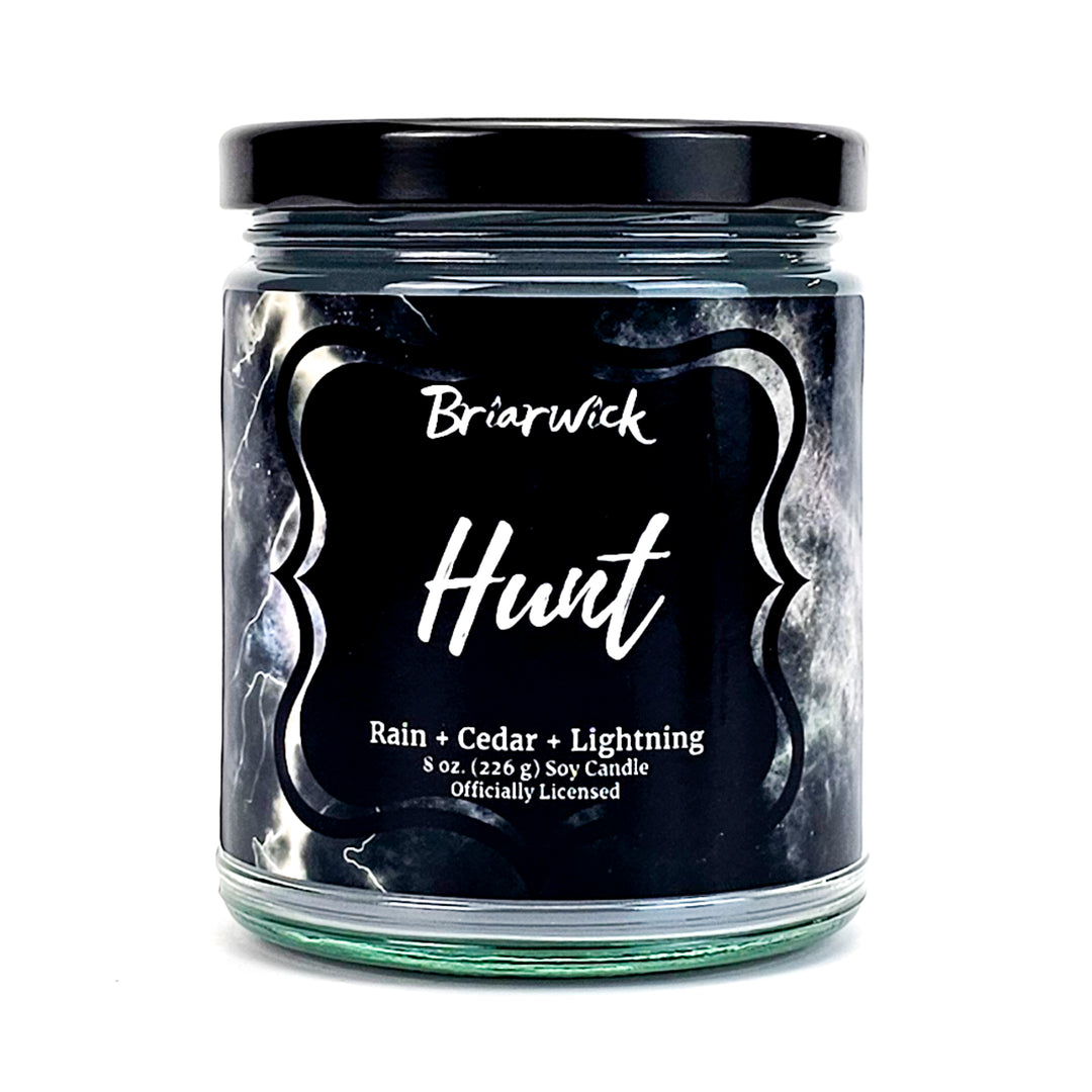 Hunt 8oz silver candle with gray storm design on a white background