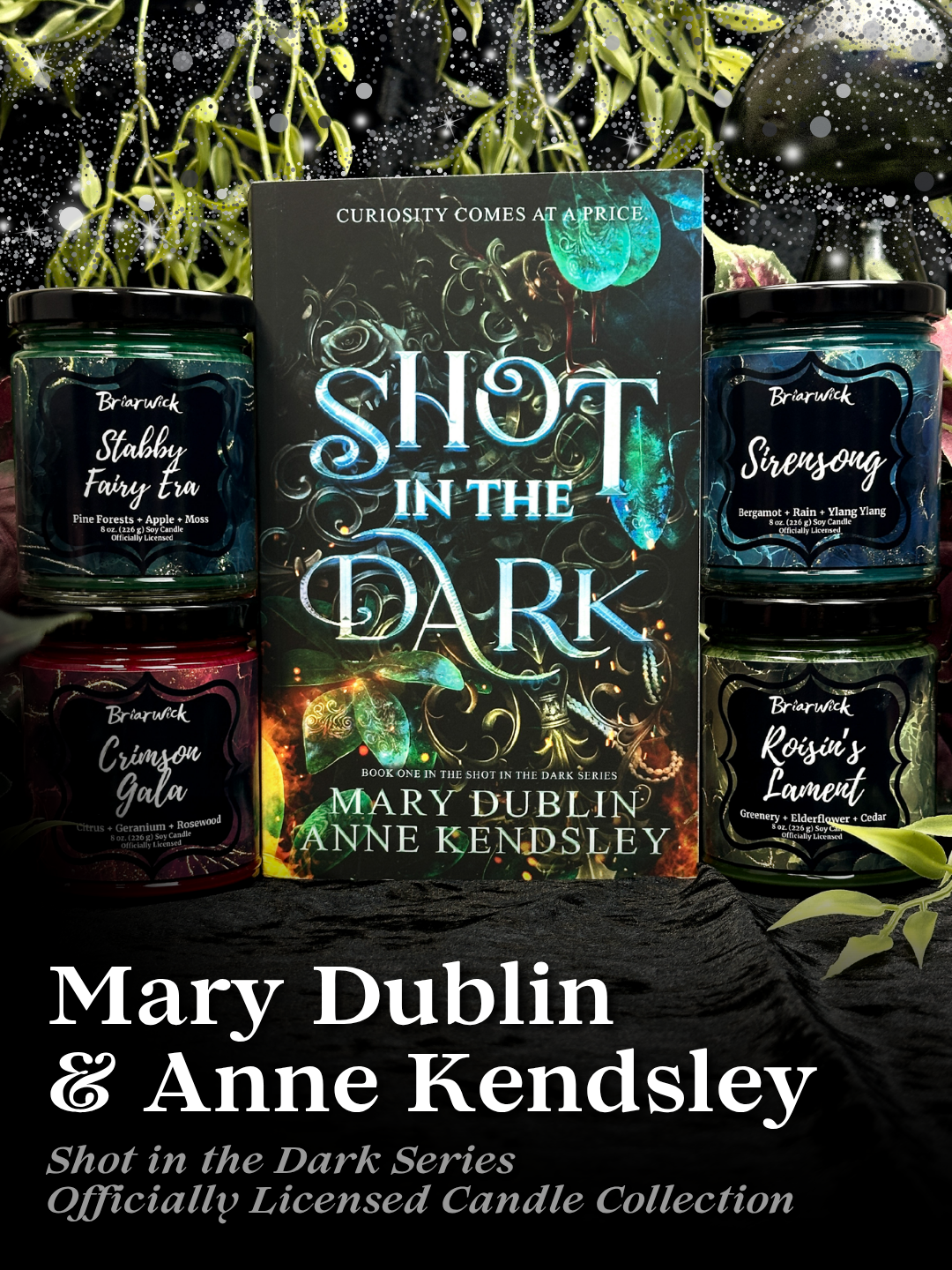 Shot in the Dark book with green Stabby Fairy Era, Red Crimson Gala, blue Sirensong, and green Roisin's Lament candles with text reading "Mary Dublin & Anne Kendsley: Shot in the Dark Series officially licensed candle collection"