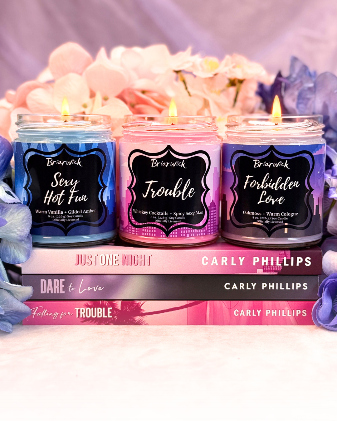 Carly Phillips Collection with pink, blue, and purple candle 