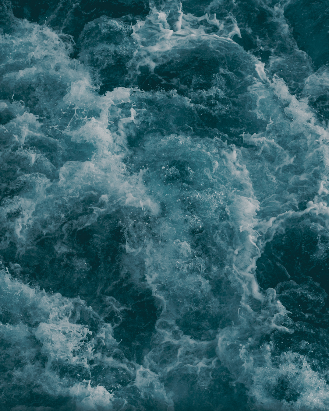 Close-up of turbulent water with dark blue and white colors