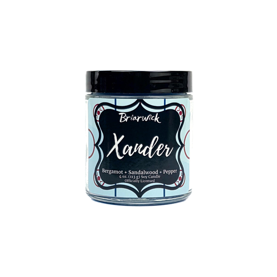Blue candle with hockey themed Xander label on a white background