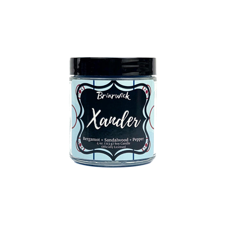 Blue candle with hockey themed Xander label on a white background