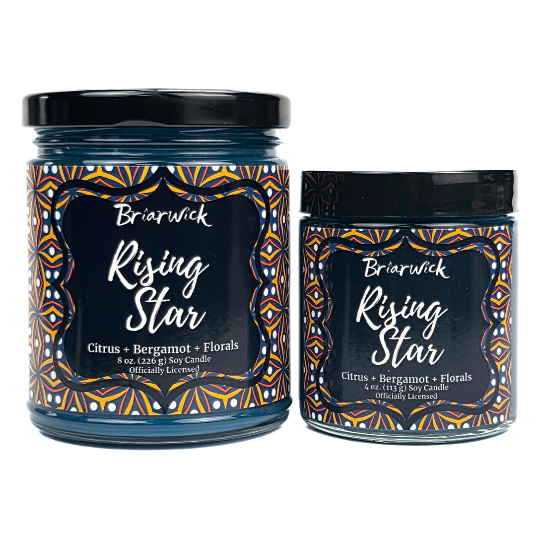 Two Briarwick Rising Star candles with decorative labels on a white background