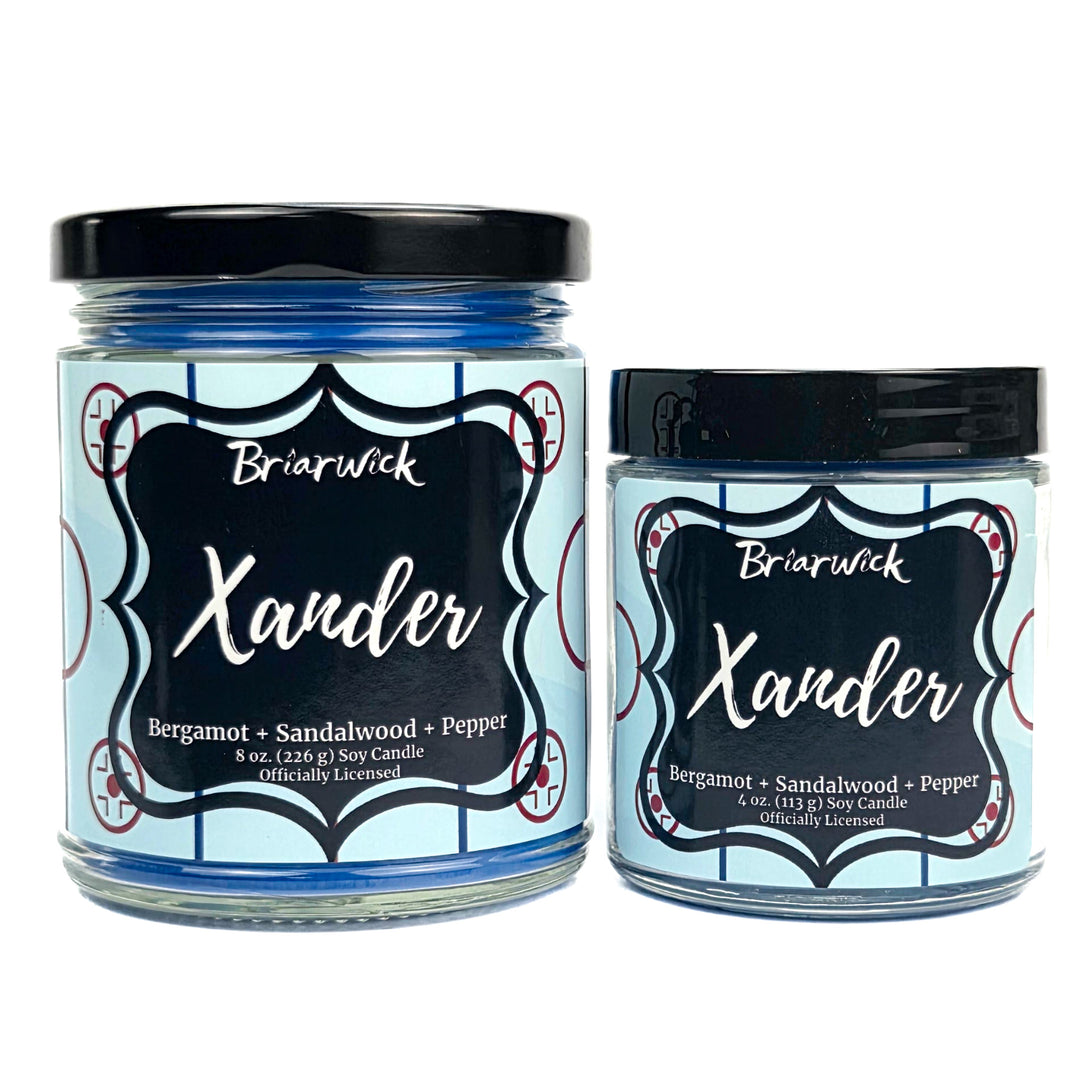 Two Briarwick Xander candles with blue hockey labels on a white background