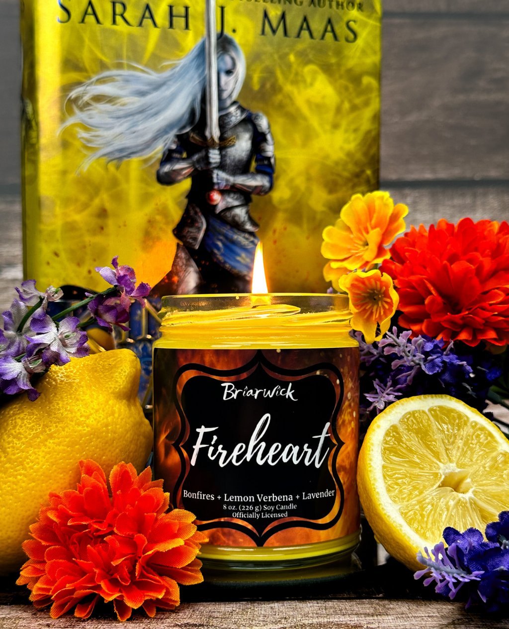 Candle labeled 'Fireheart' by Briarwick with Sarah J. Maas' book Throne of Glass in the background