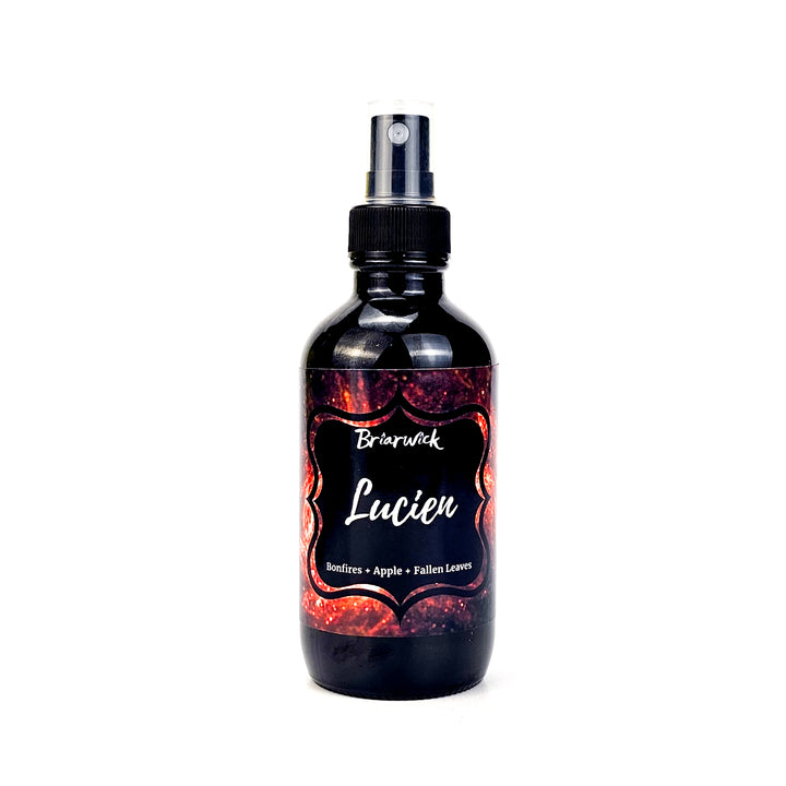 Lucien 4oz Linen Spray with orange galaxy design on a white background