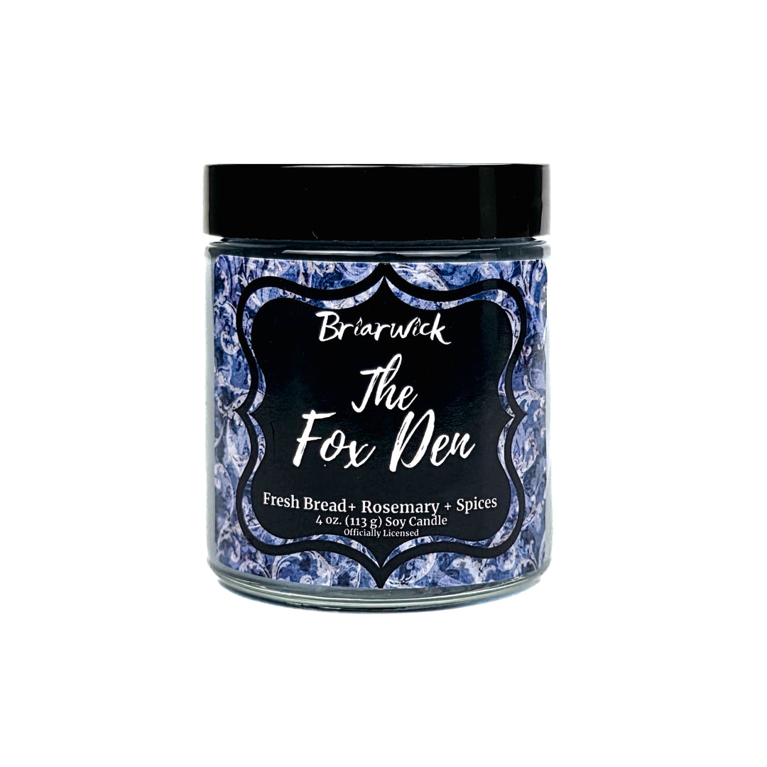 A jar candle from Briarwick The Fox Den with a black lid and a blue-and-white patterned label, shown on a plain white background.