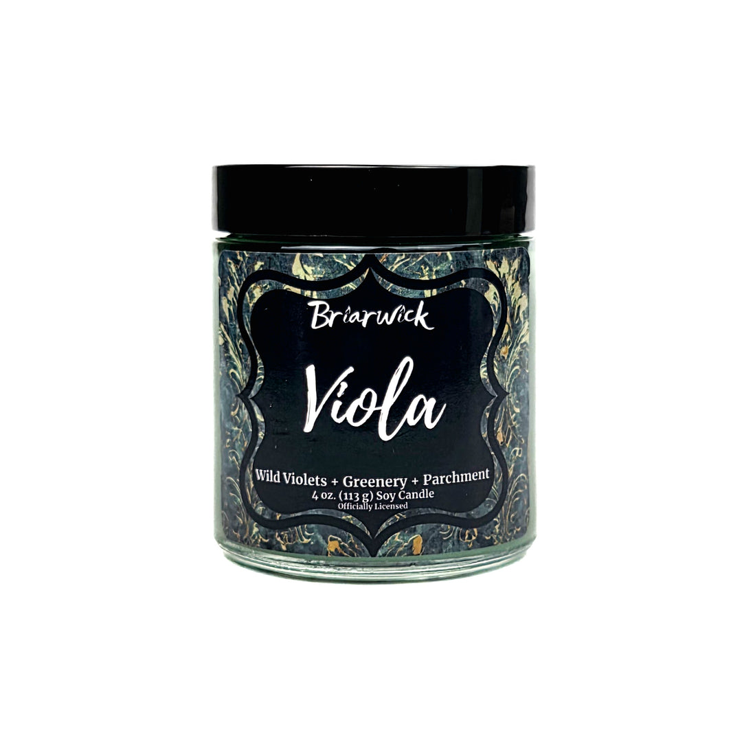 A jar candle labeled Briarwick Viola, featuring a black lid and a dark label with ornate gold and green patterned borders on a white background.