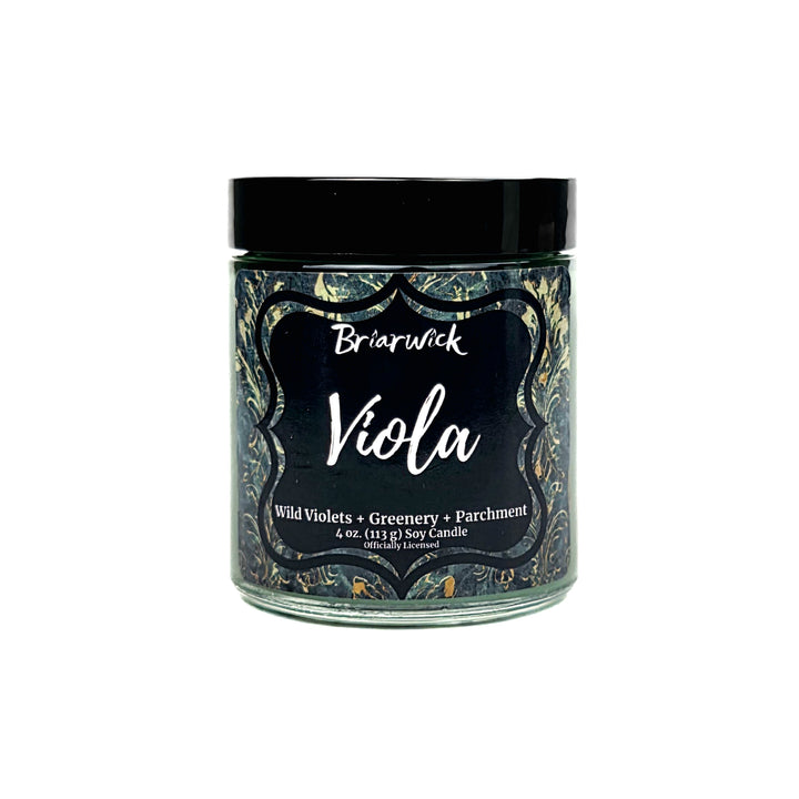 A jar candle labeled Briarwick Viola, featuring a black lid and a dark label with ornate gold and green patterned borders on a white background.