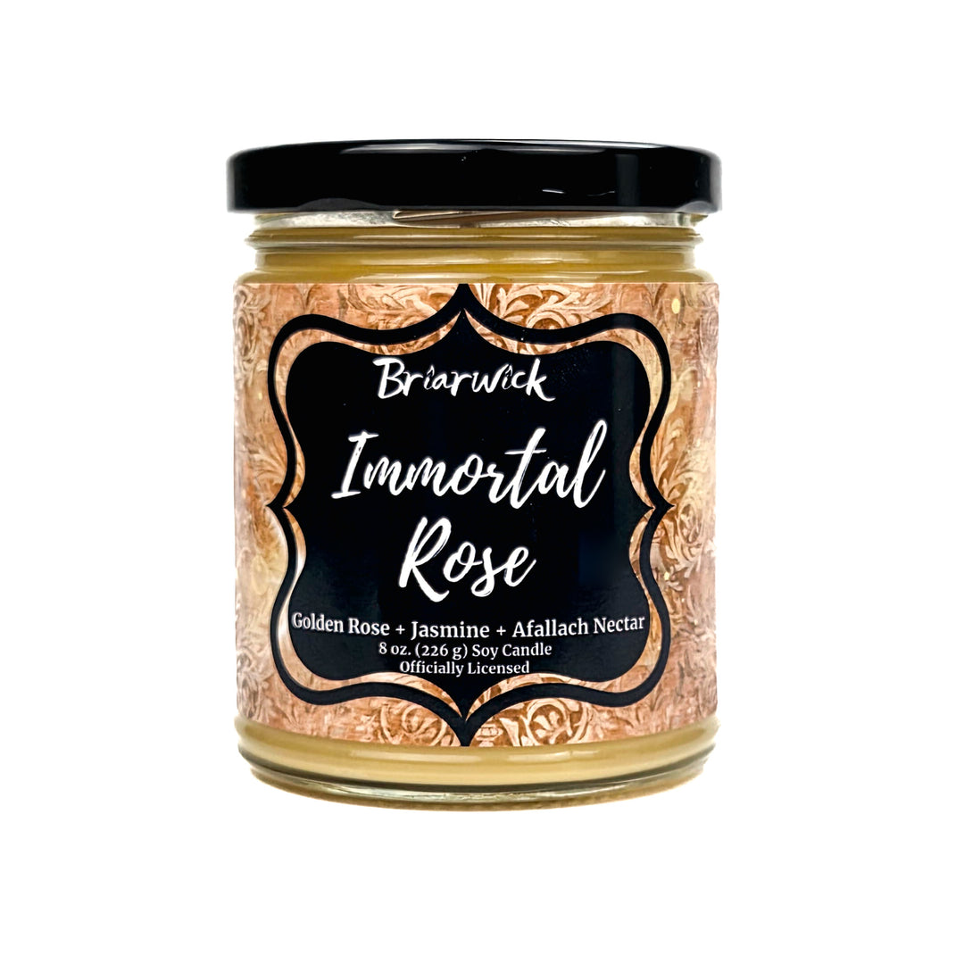 A jar candle labeled 'Briarwick Immortal Rose' with a black lid and a decorative label featuring a gold rose pattern on a white background.