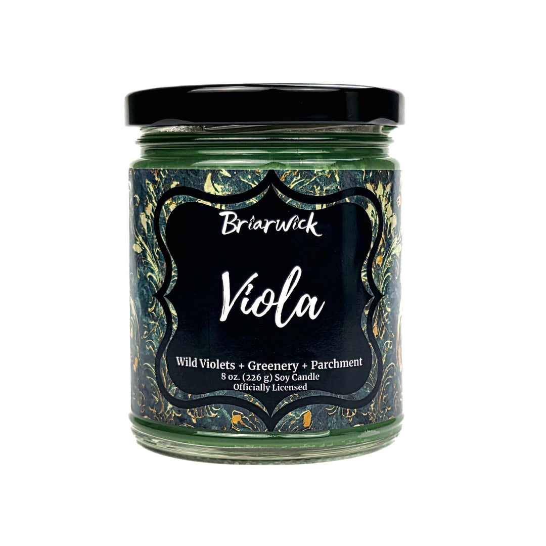 A Briarwick 'Viola' soy candle in a clear glass jar with a black lid and a black label featuring a dark green and gold marbled pattern.