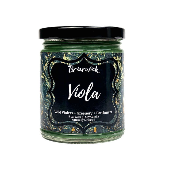 A Briarwick 'Viola' soy candle in a clear glass jar with a black lid and a black label featuring a dark green and gold marbled pattern.