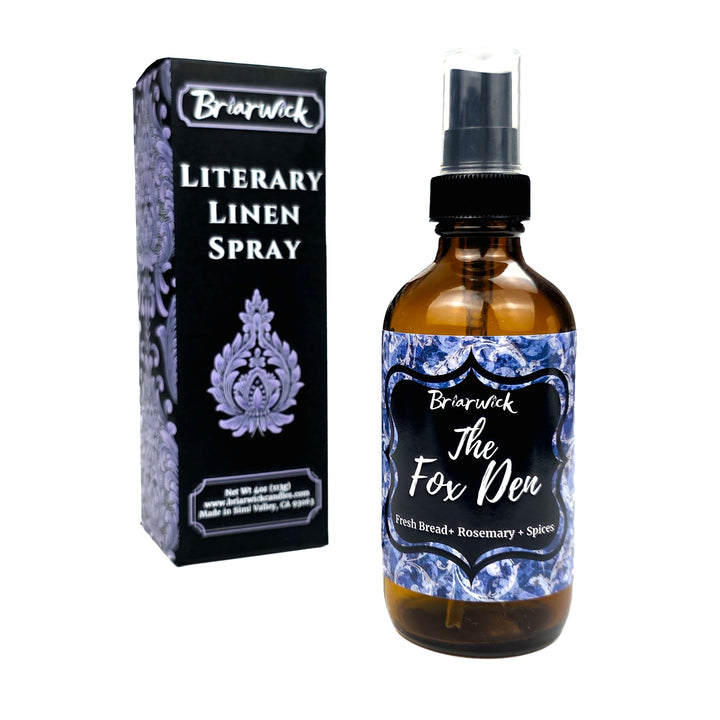 A bottle of Briarwick Literary Linen Spray next to its black packaging box, featuring a blue and white damask pattern with white text on a clean white background.