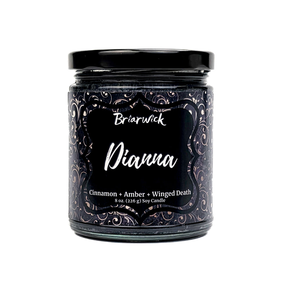 Dianna 8oz black candle with a silver ornamental pattern on a white background