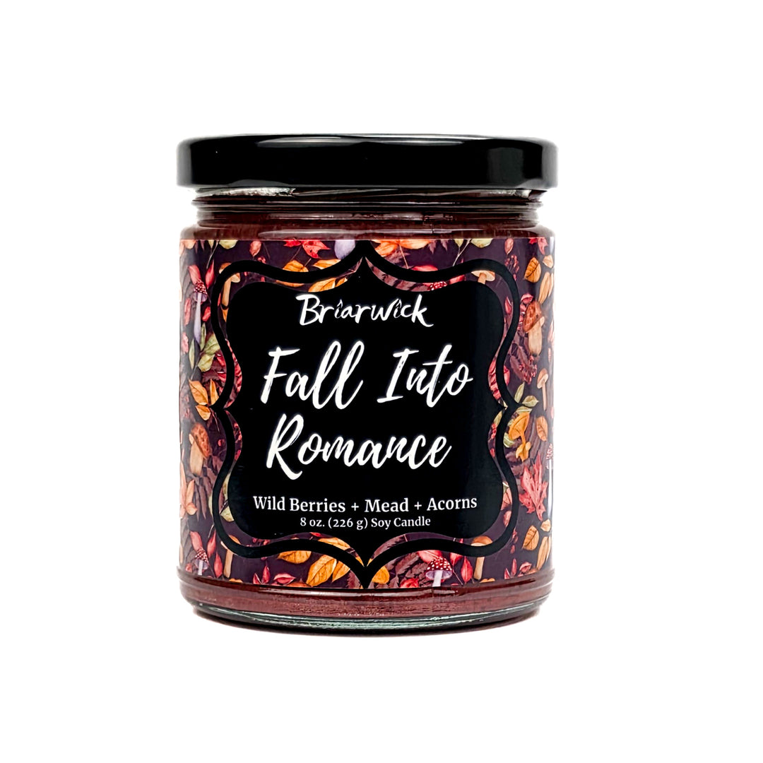 Fall Into Romance 8oz auburn candle with a foliage pattern on a white background