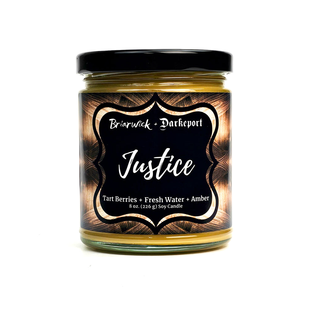 Justice 8oz gold candle with gold textural design on a white background