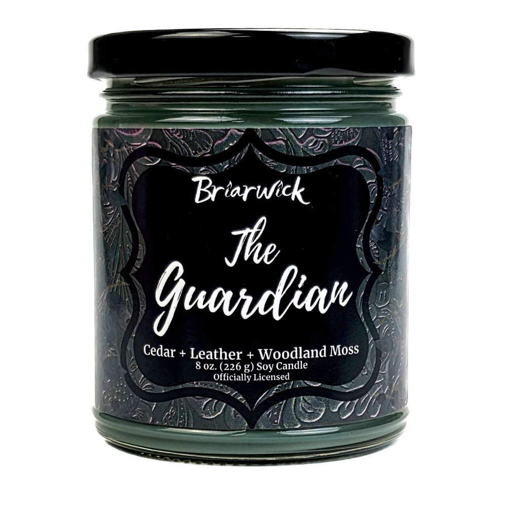 Green candle jar labeled 'The Guardian' by Briarwick with a black lid on a white background