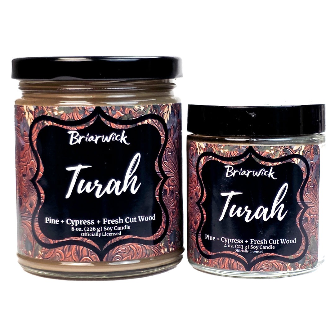 Two brown Briarwick Turah candles with decorative labels on a white background