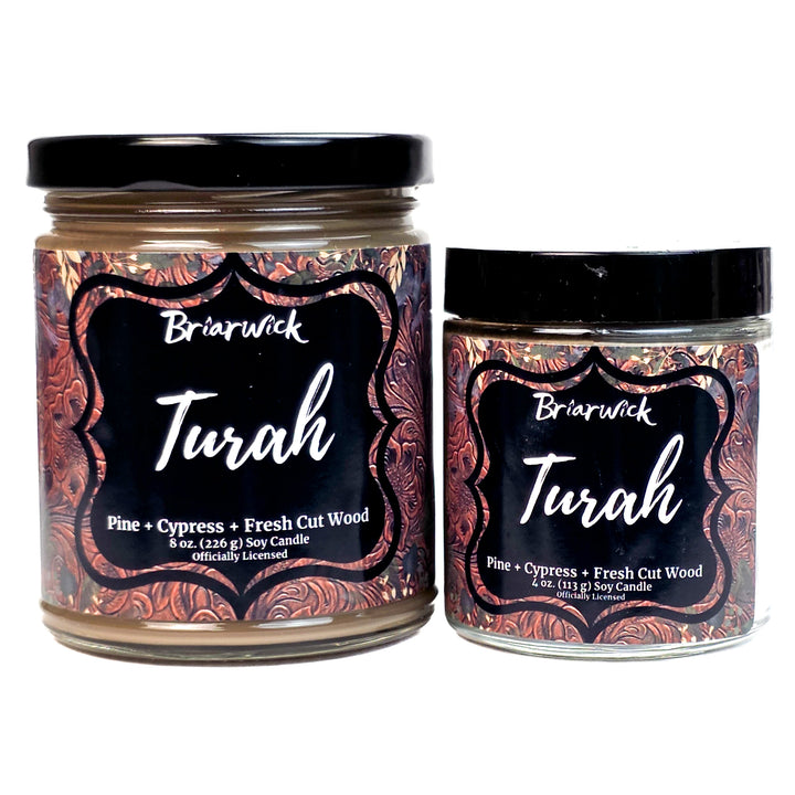 Two brown Briarwick Turah candles with decorative labels on a white background